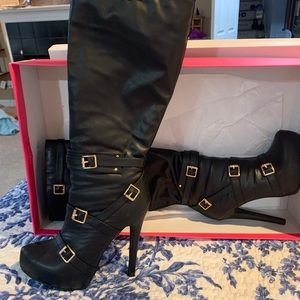 Knee high, heeled boots.